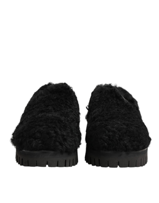 Pair of black fur lined leather slippers with rubber soles, designed for men