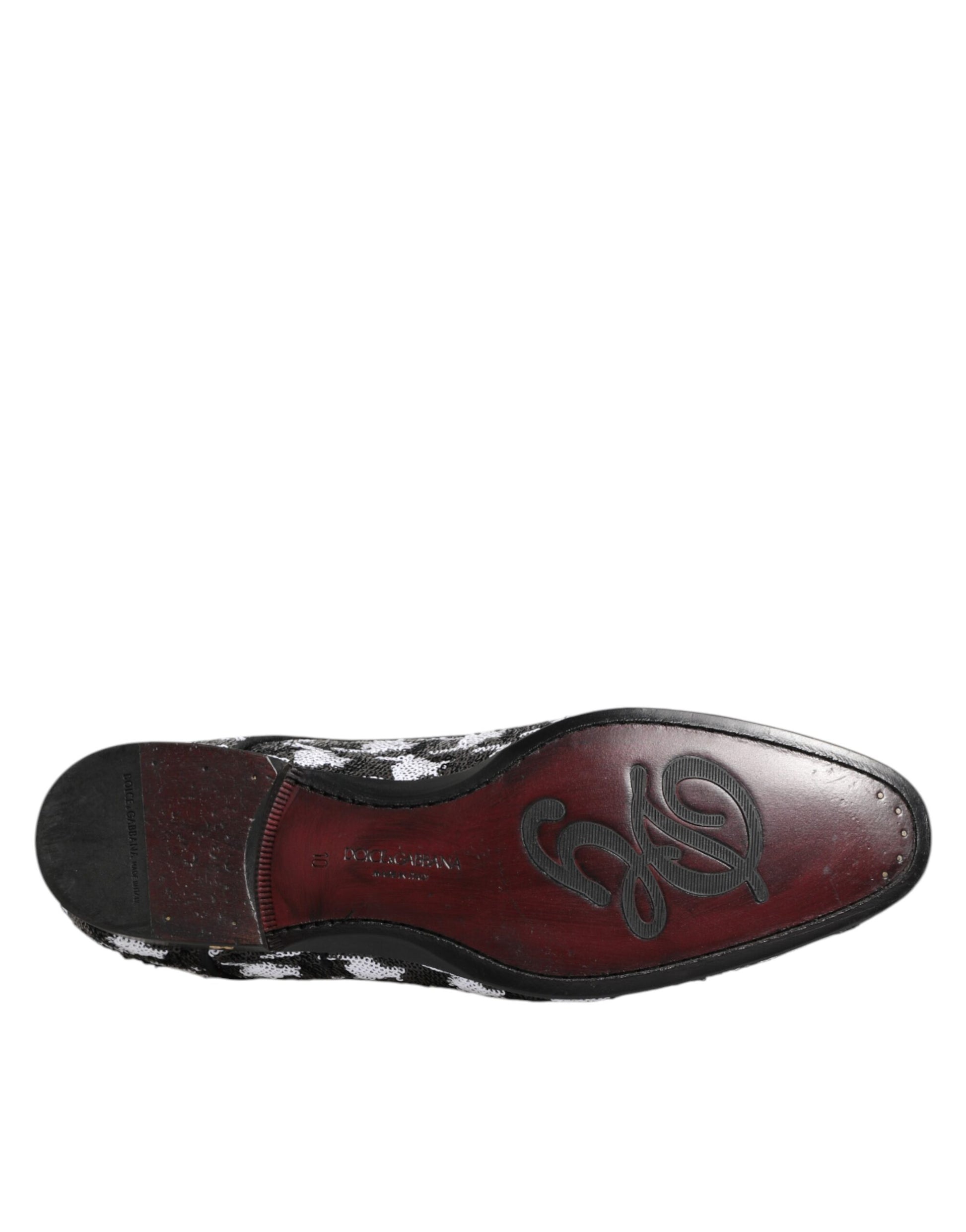 A single black and white sequined lace-up derby shoe with a distinctive design on the toe