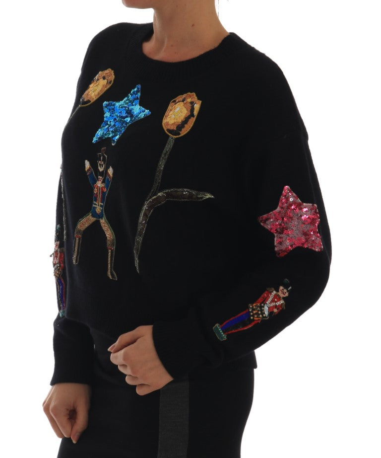 Black sweater with colorful stars and a cartoon character on front