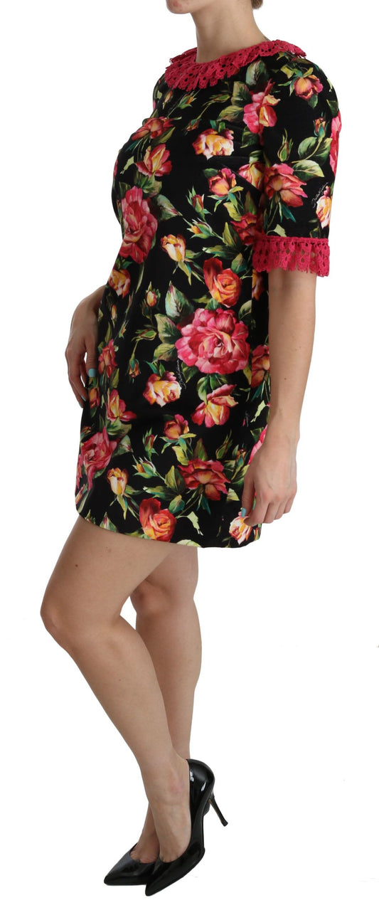 A woman wearing a floral pink lace A-line shift mini dress