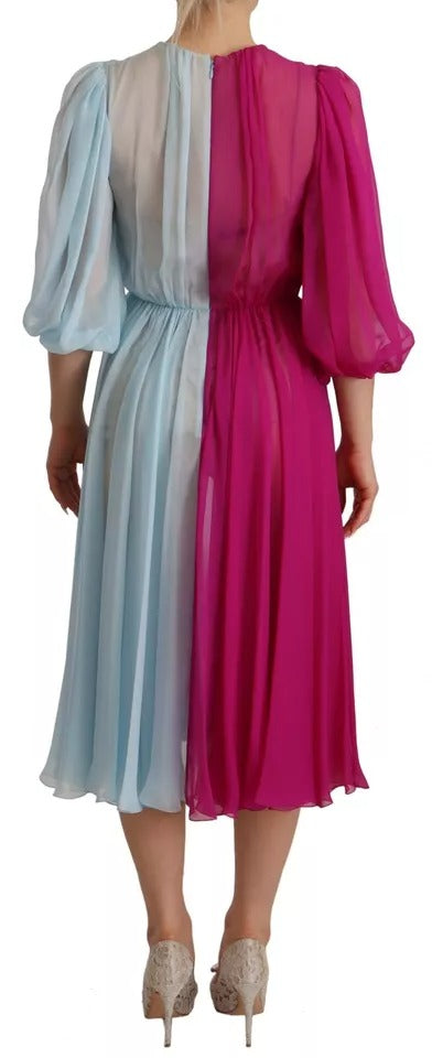 A two-tone midi dress in fuchsia and light blue silk, featuring a ruffled hem