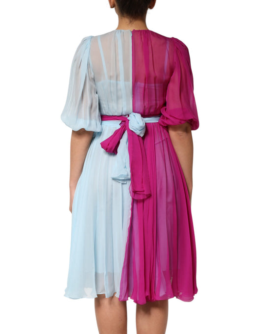 A fuchsia light blue silk two tone midi dress with ruffled sleeves and a bow at the waist