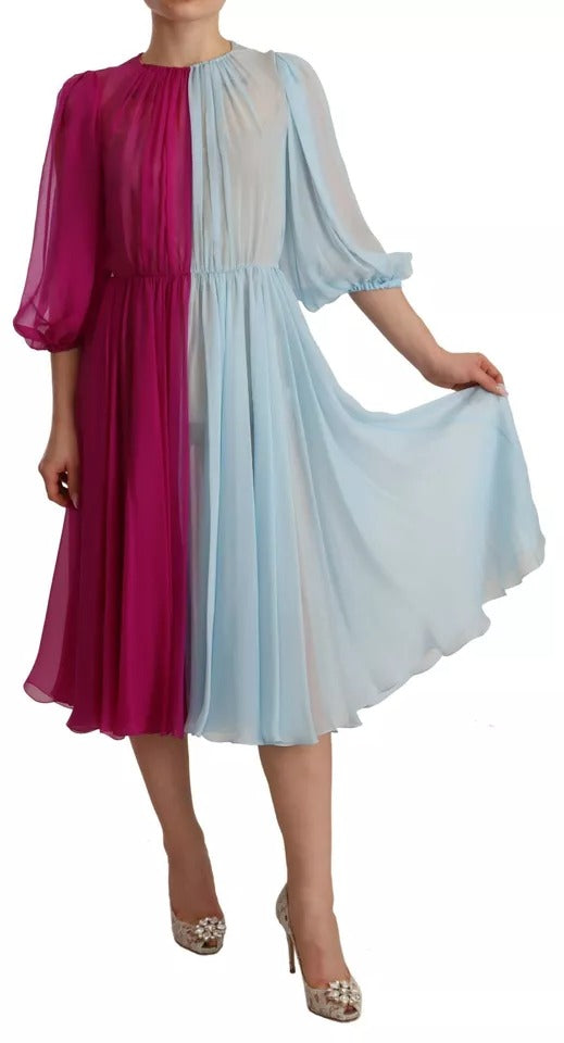 A woman wearing a two-tone midi dress with a fuchsia top and light blue skirt
