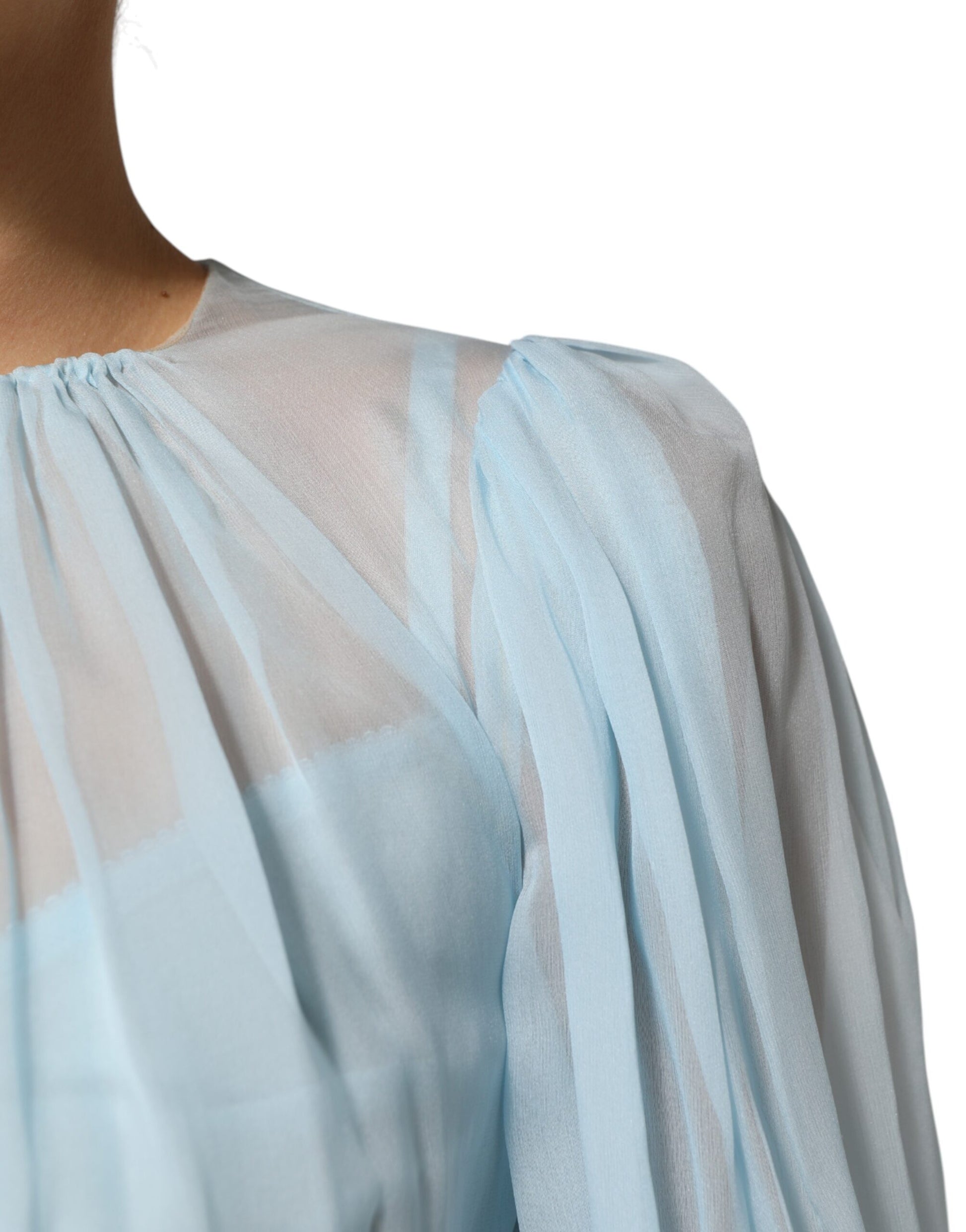 A light blue silk dress with a two-tone design and ruffled sleeves