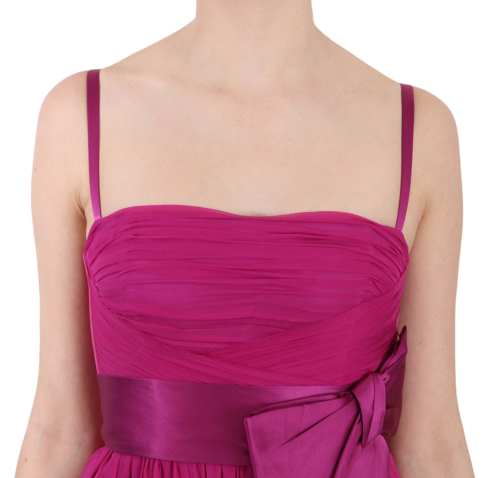 A sleeveless pink dress with a bow at the waist