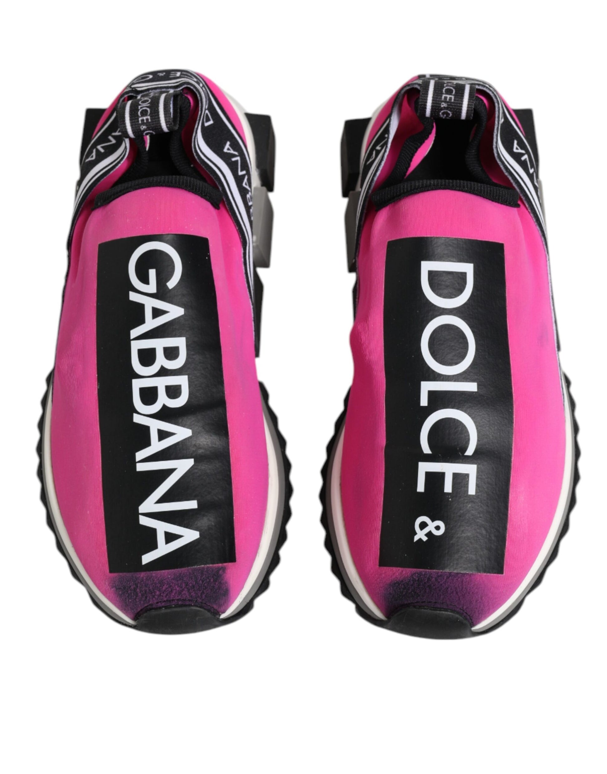Pink sneakers with white lettering on soles