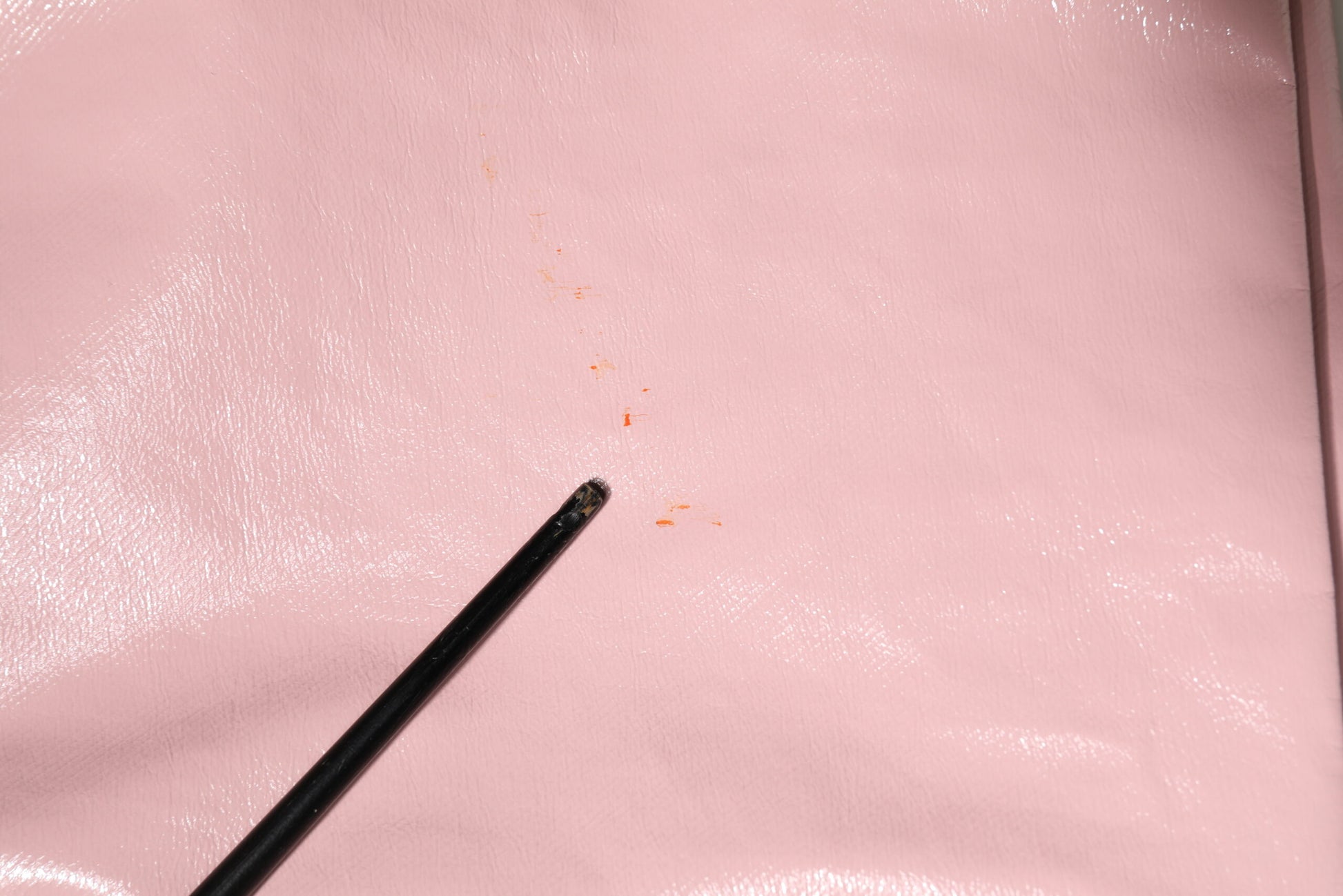 Black pen on pink fabric