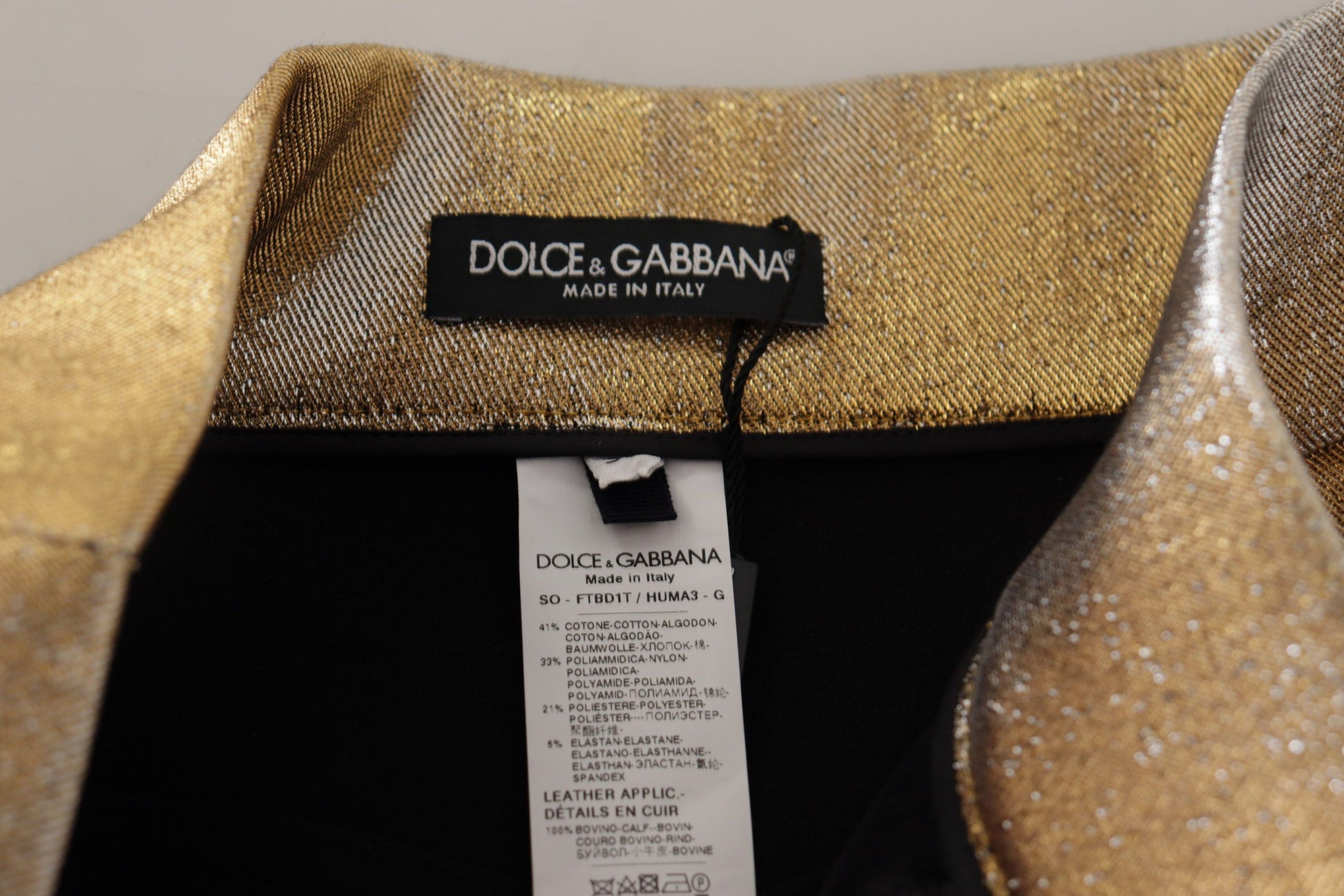 Black shirt with gold sequins on sleeve