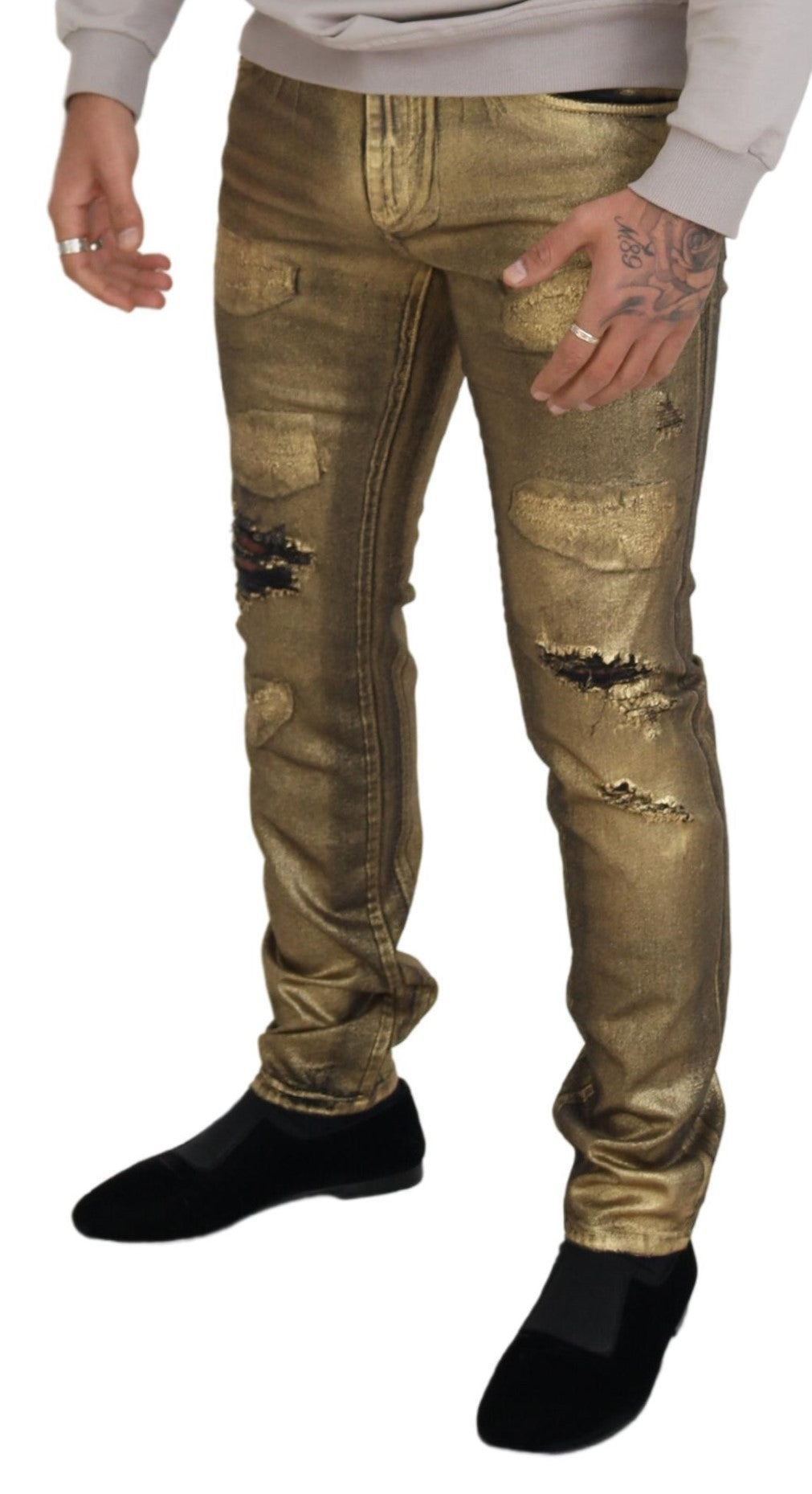 Man wearing gold pants and black shoes