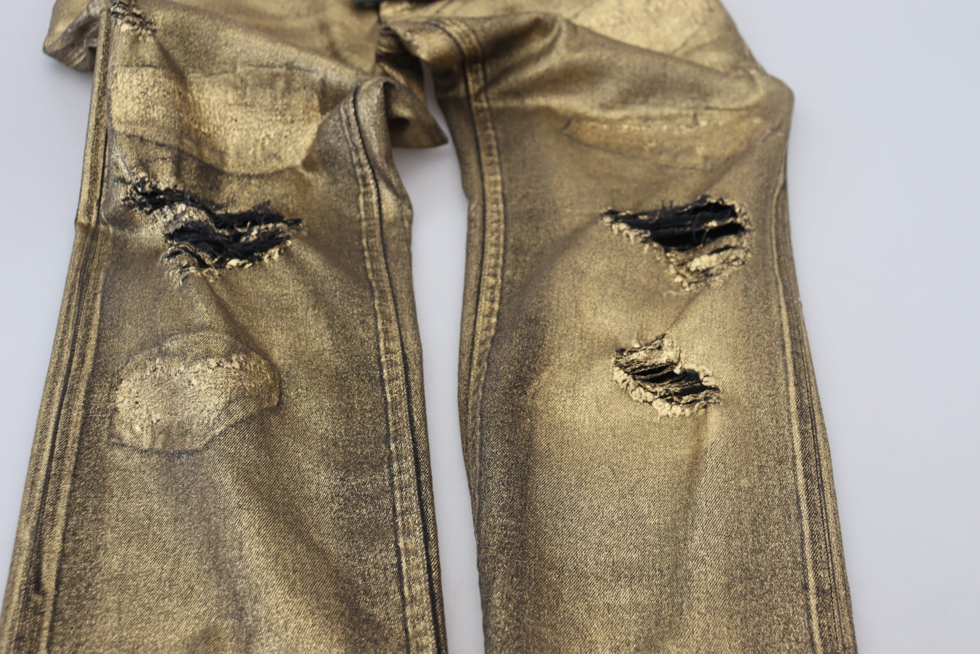 Gold sequined jeans with rips on knees