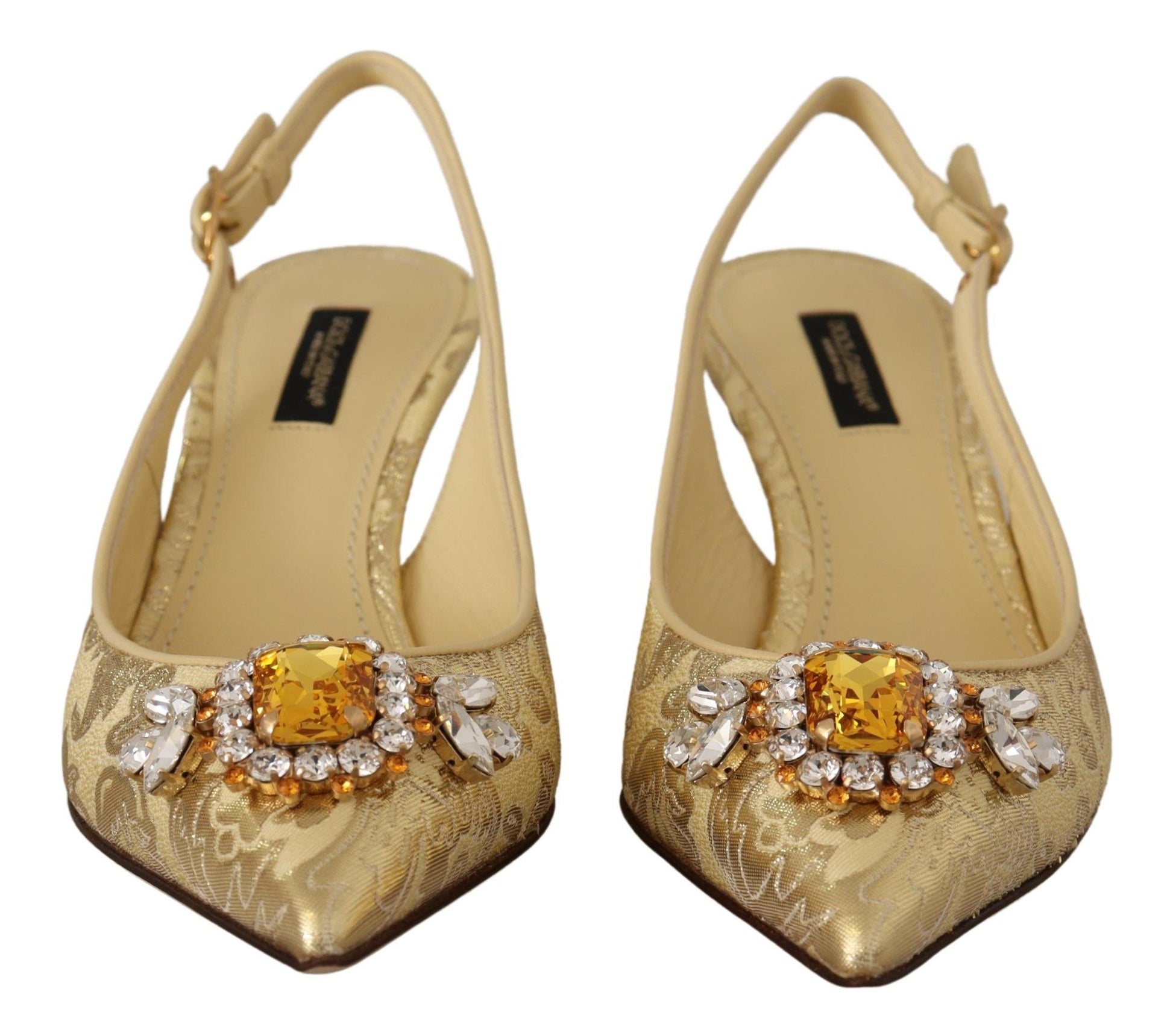 Pair of gold high heel shoes with embellishments and straps