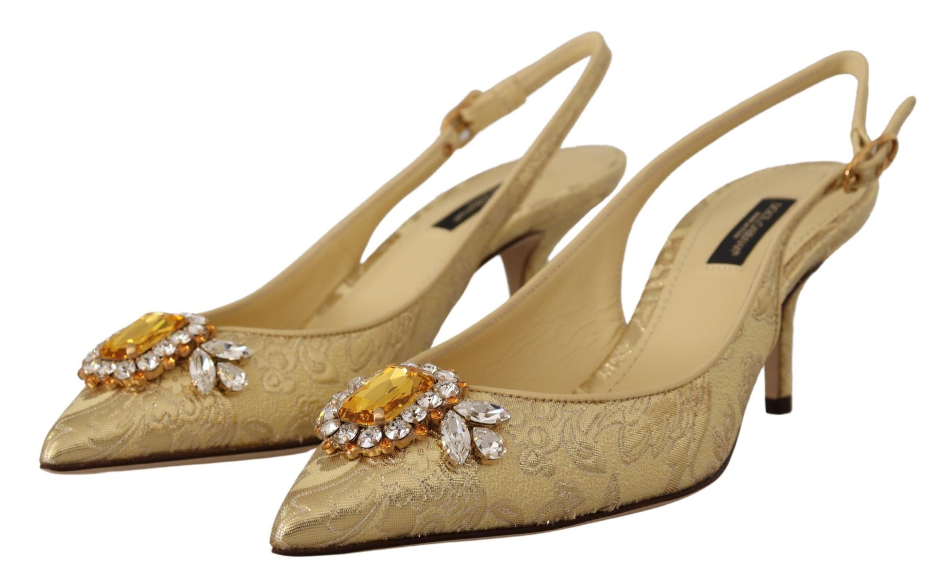 Pair of gold high heel shoes with embellishments on toes