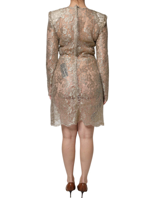 A woman wearing a gold floral lace A-line sheath mini dress