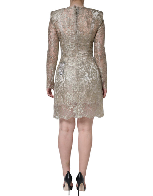 A woman wearing a gold floral lace A-line sheath mini dress