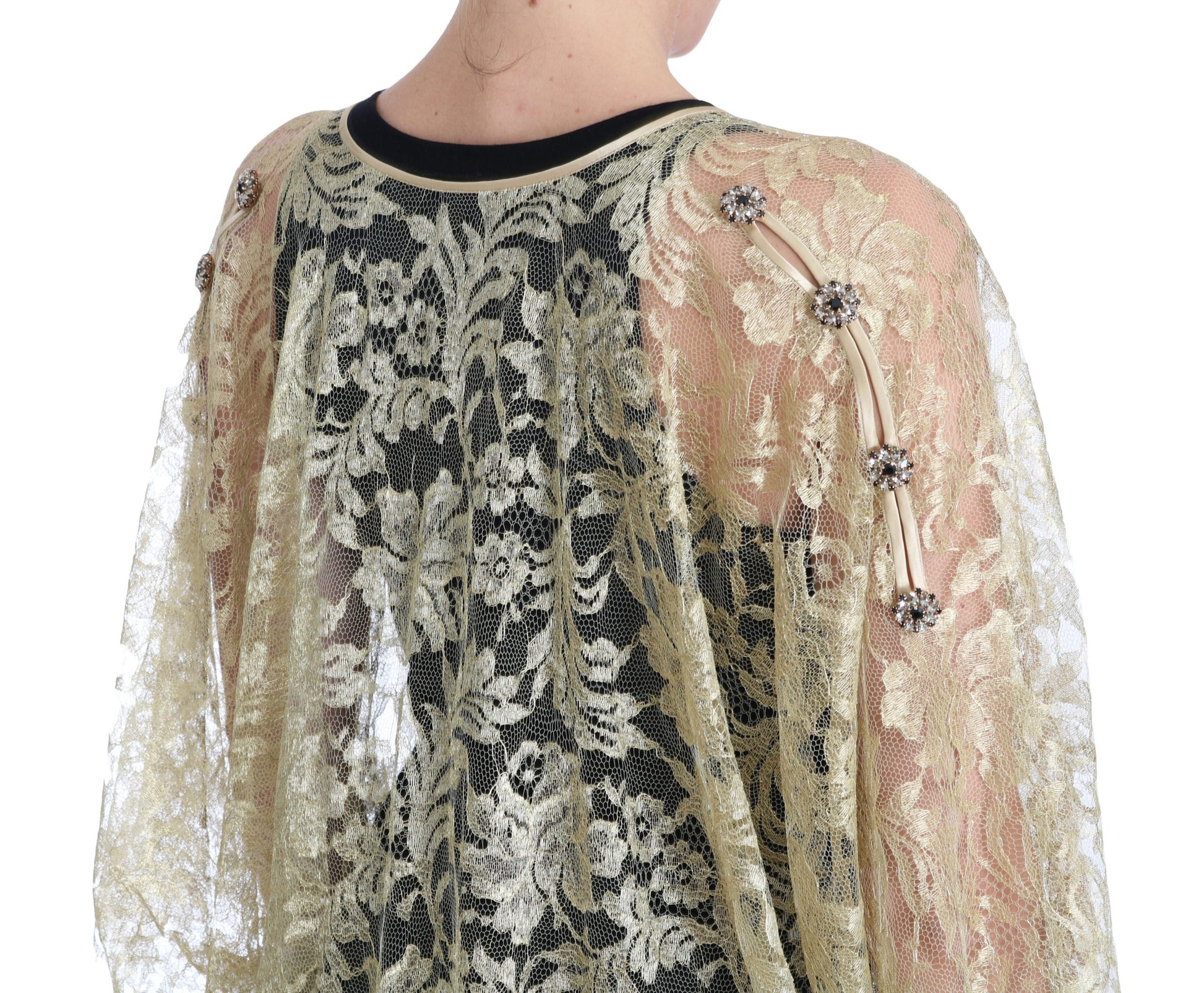A gold floral lace cape dress with crystal embellishments