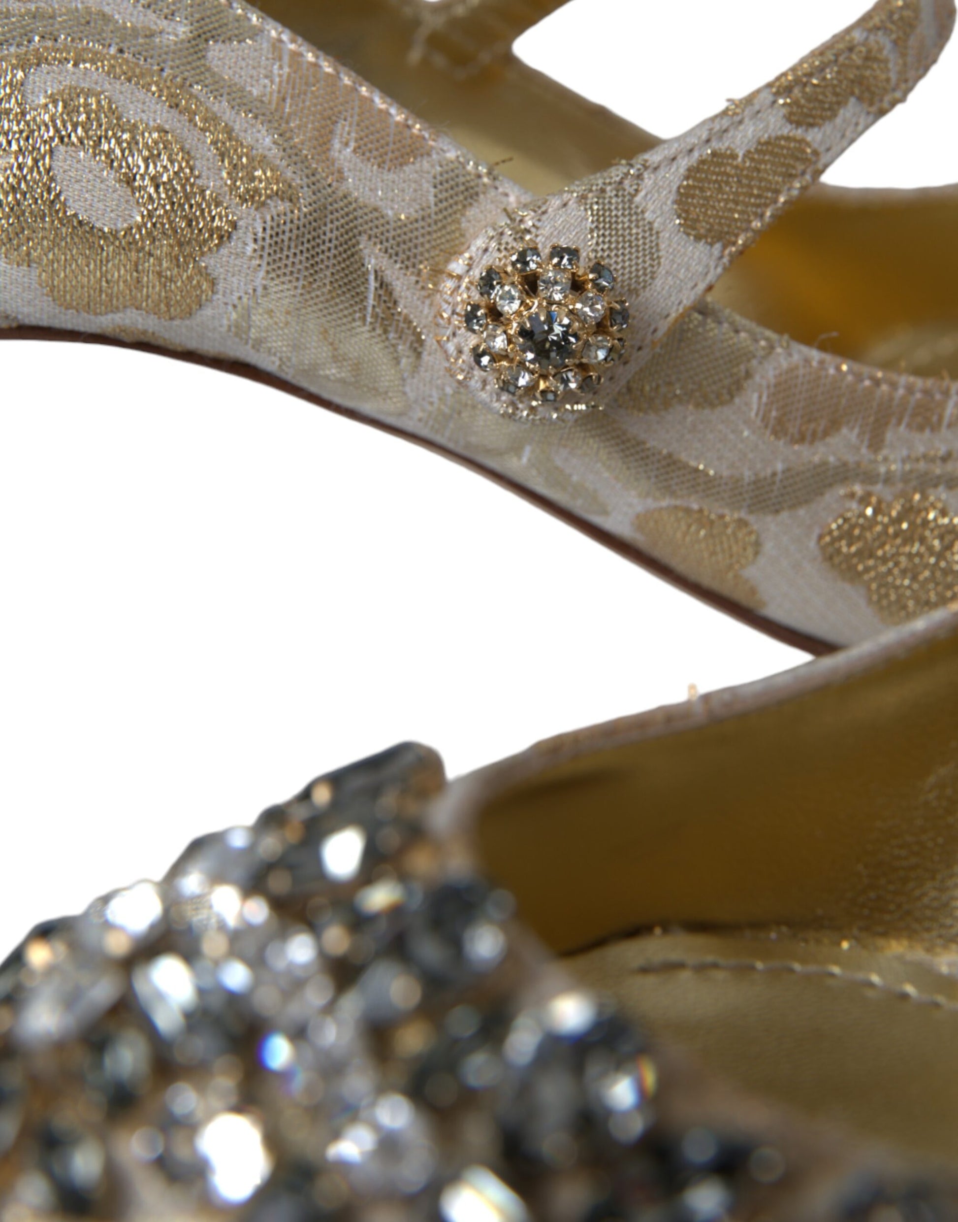 Pair of gold glittery high heel shoes with rhinestone embellishments