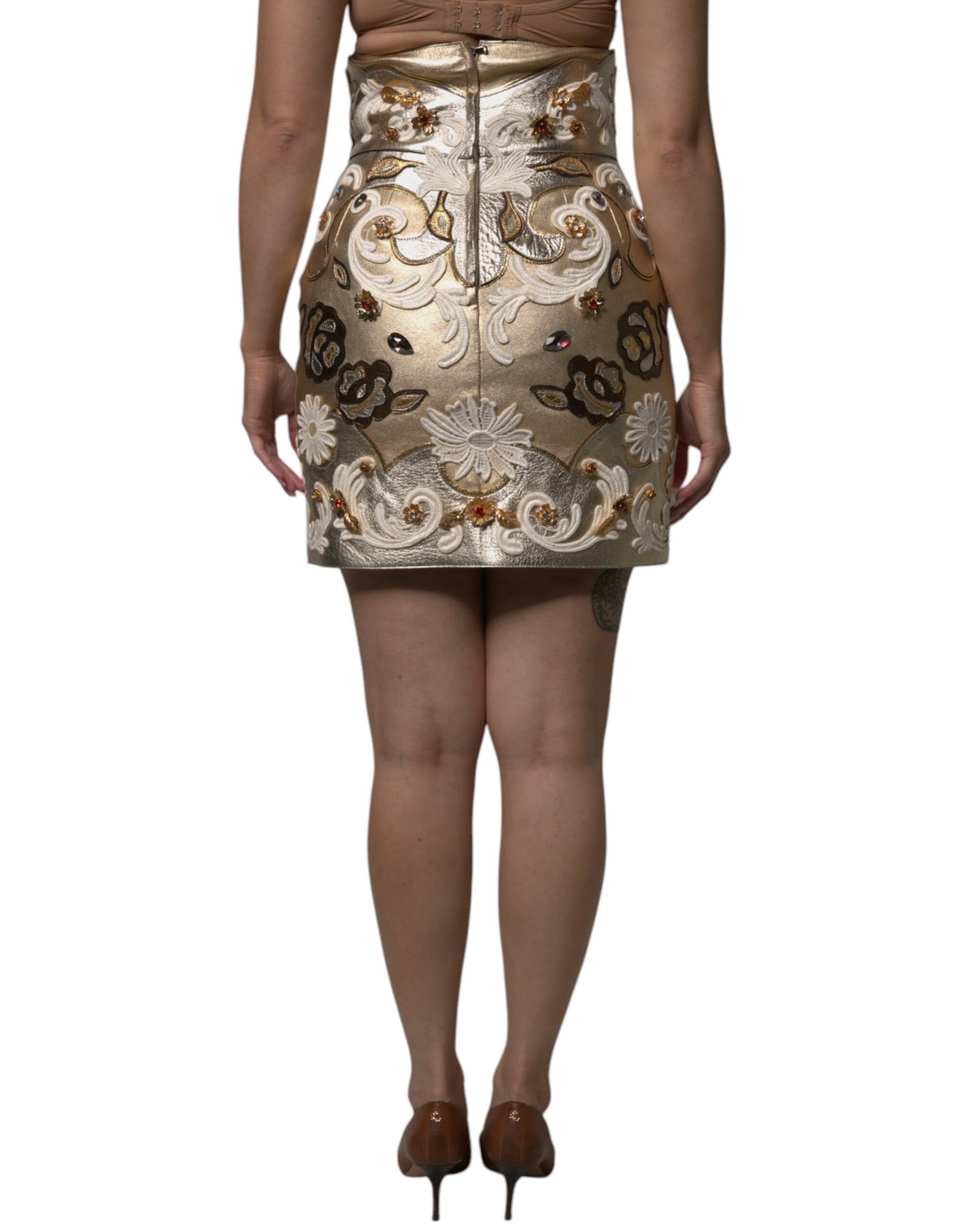 Woman wearing a short dress with intricate designs on bodice