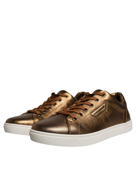 Gold leather sneakers with white soles, featuring a logo on the side