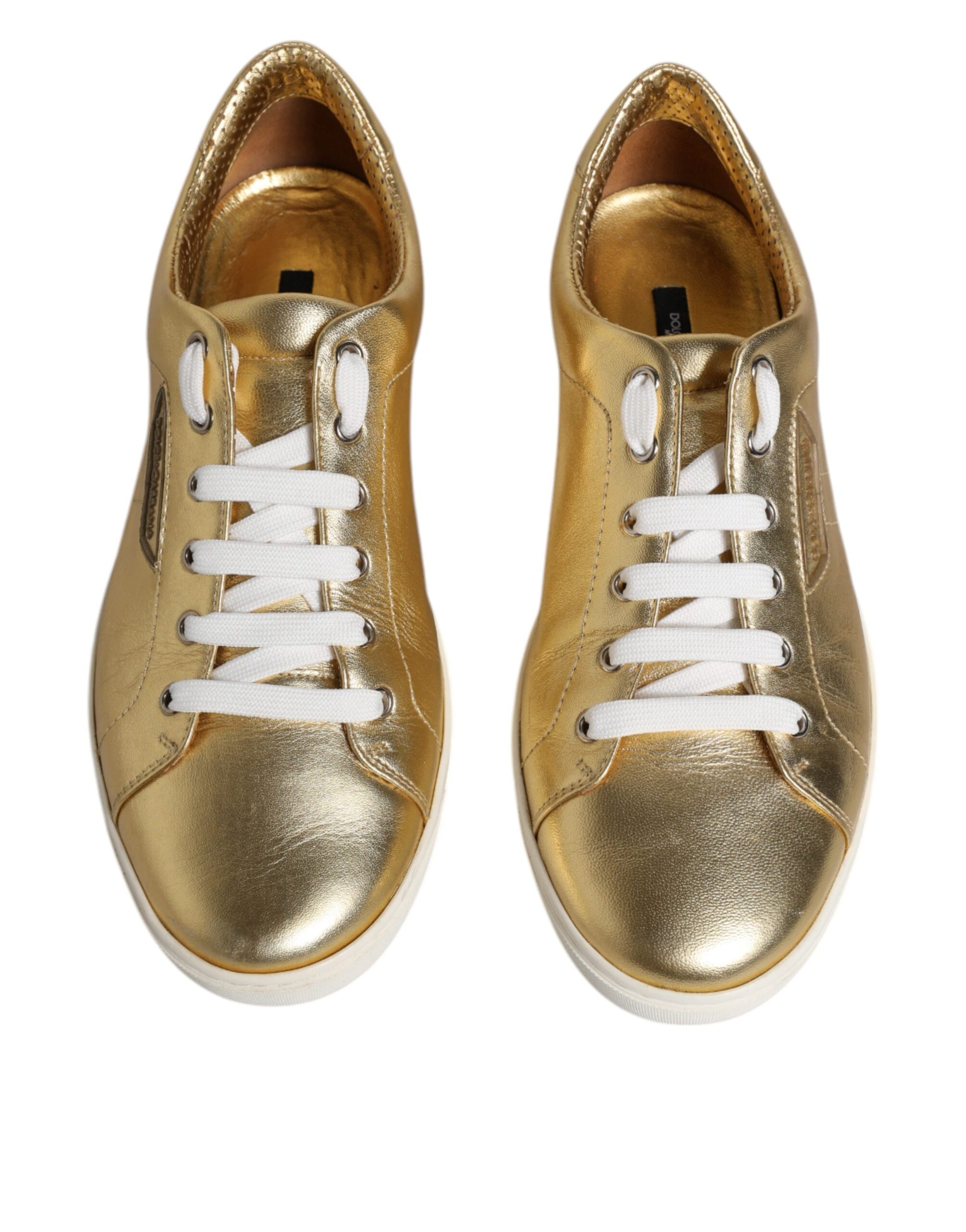Pair of gold glitter sneakers with white laces and soles