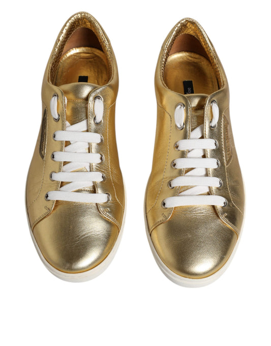 Pair of gold glitter sneakers with white laces and soles