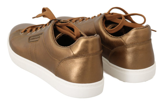 Pair of gold glittery sneakers with white soles and laces