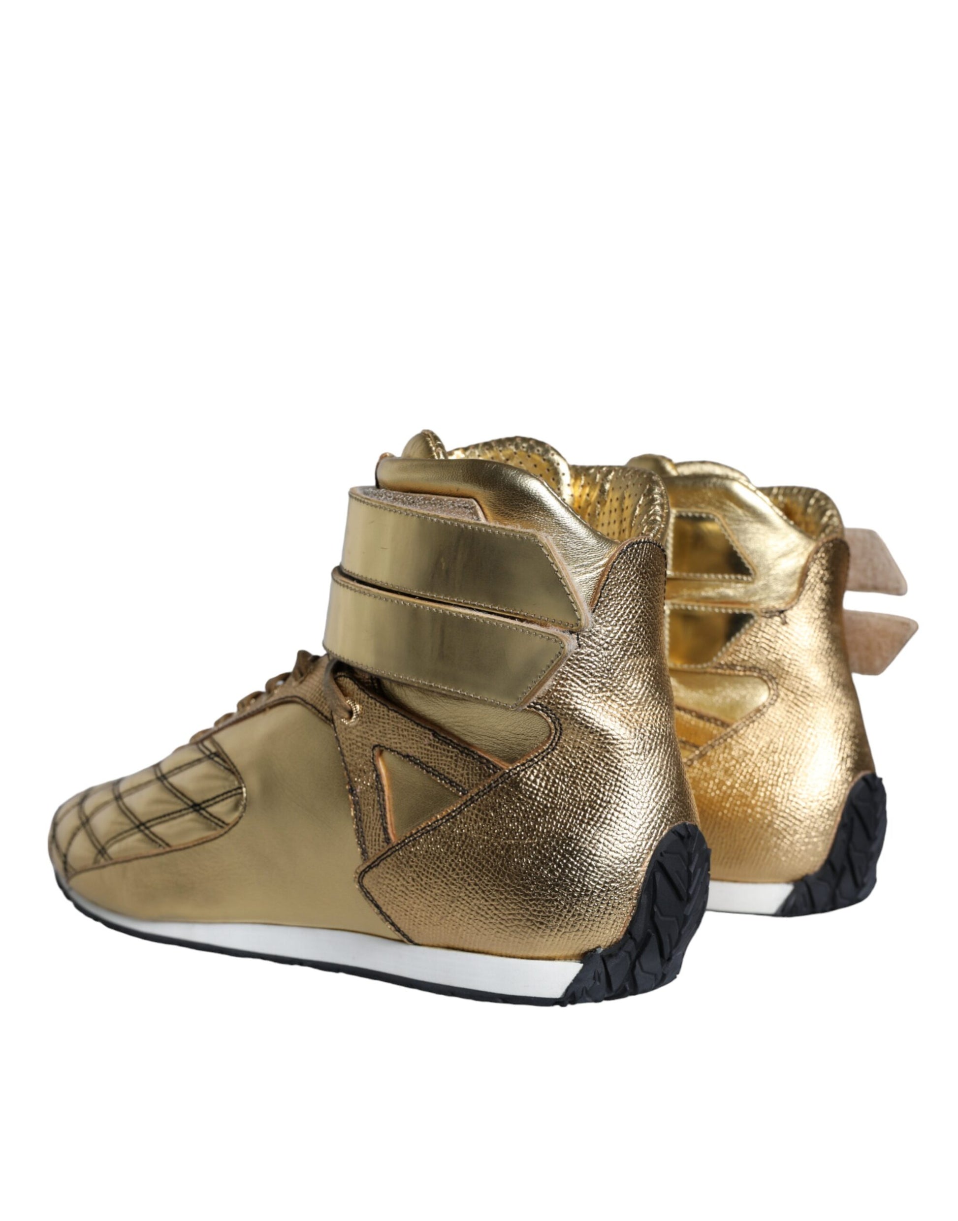 Pair of gold leather high top sneakers with laces and a logo on the side