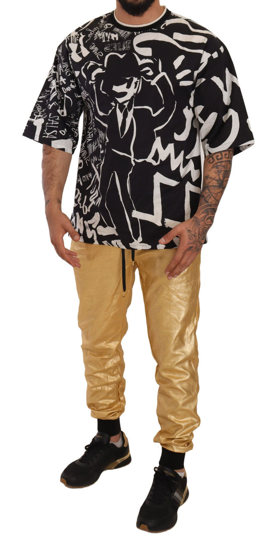 Man wearing black t-shirt with white design and gold pants