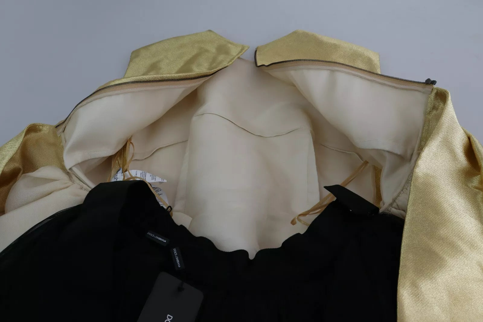 A gold polyester sleeveless dress with an A-line silhouette. It features tulle fabric and is designed by Dolc