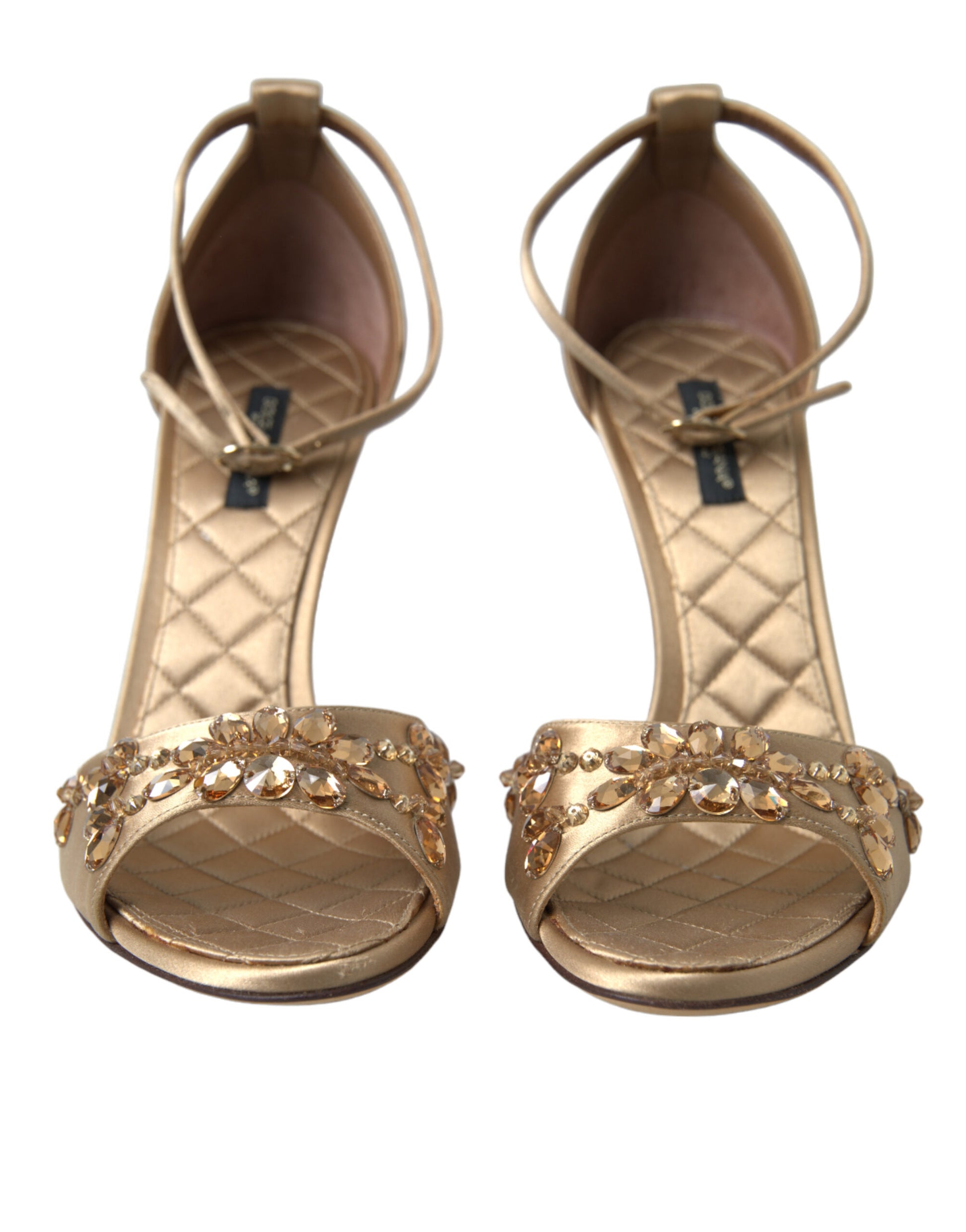 Pair of women's gold high heel sandals with embellishments and straps
