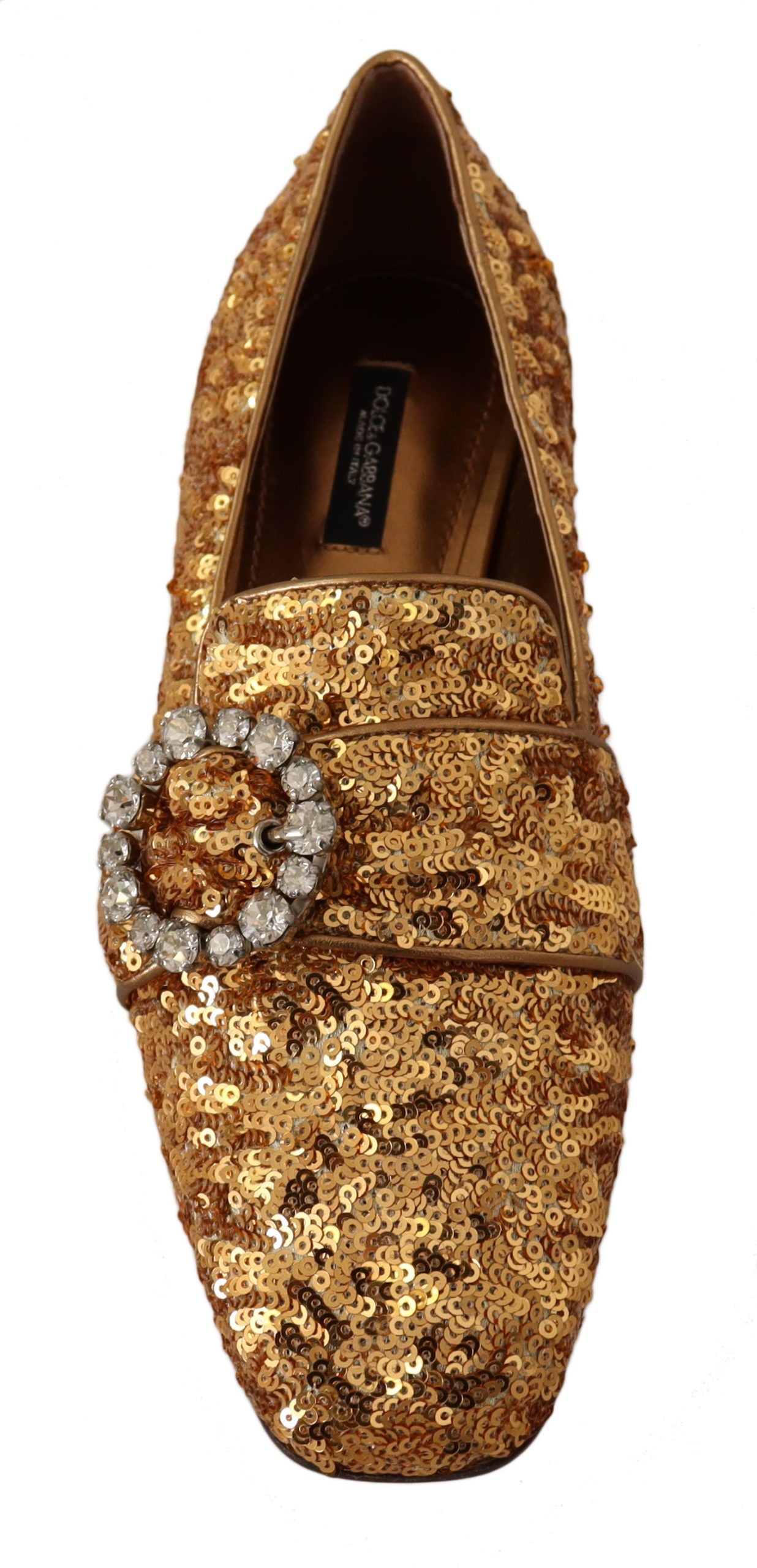 Gold glittery shoe with a large jewel on top of the toe cap