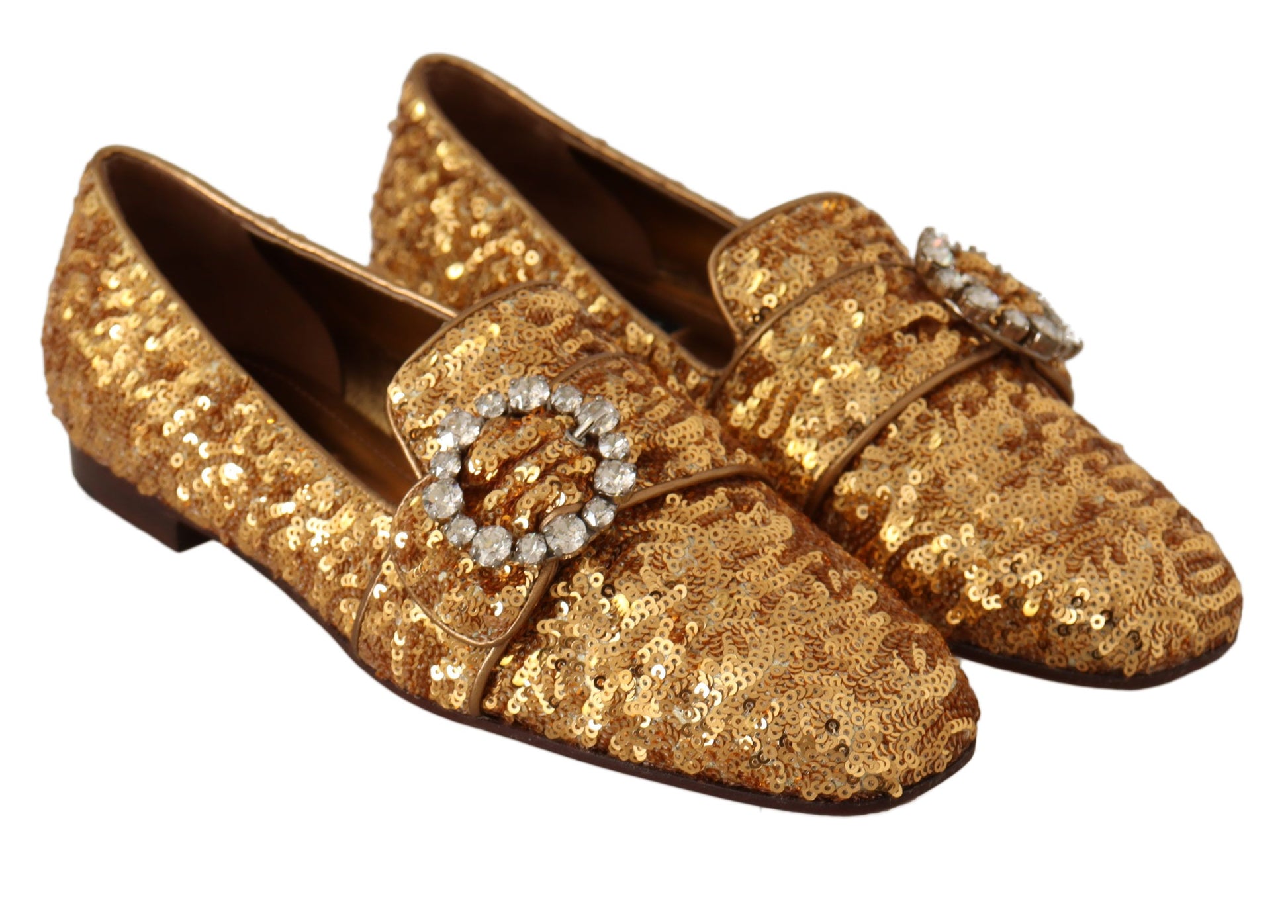 Pair of gold glittery women's shoes with rhinestones and a bow on top
