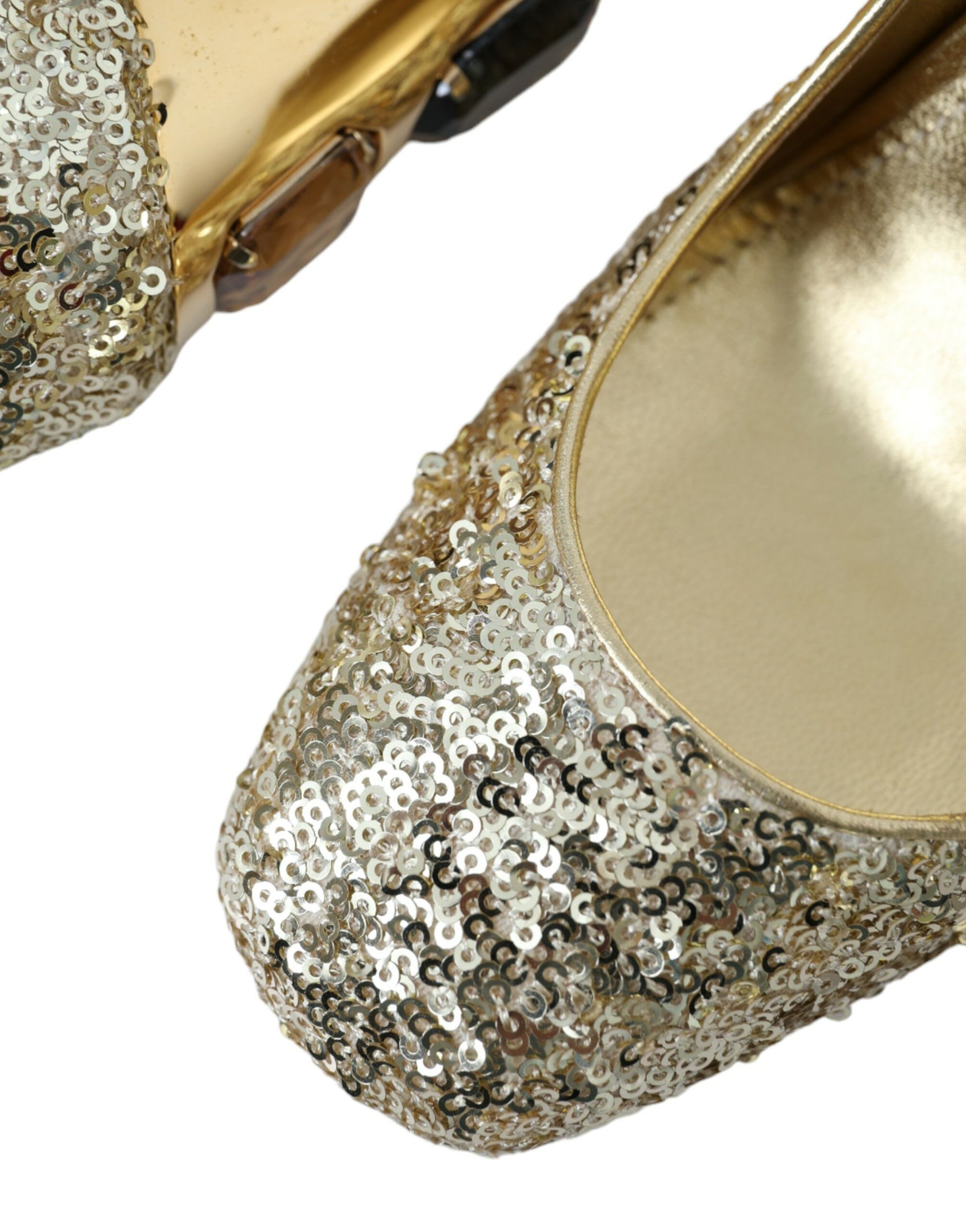 Pair of gold glittery women's shoes with embellishments and a bow on top