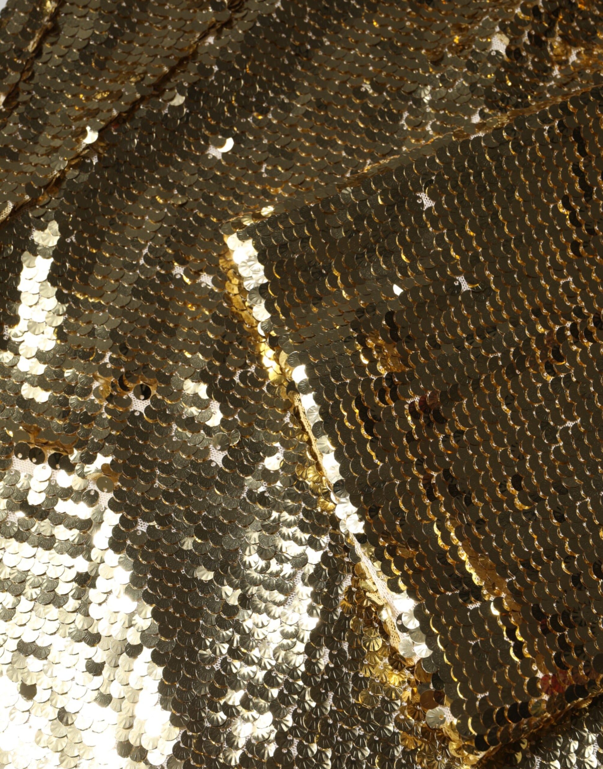 A gold sequin long sleeve mini dress
