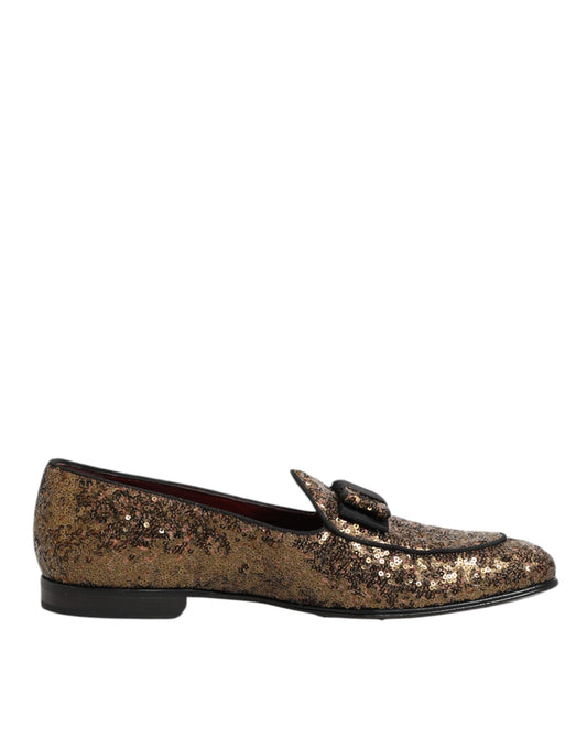 A pair of gold sequined loafers with a slip-on design