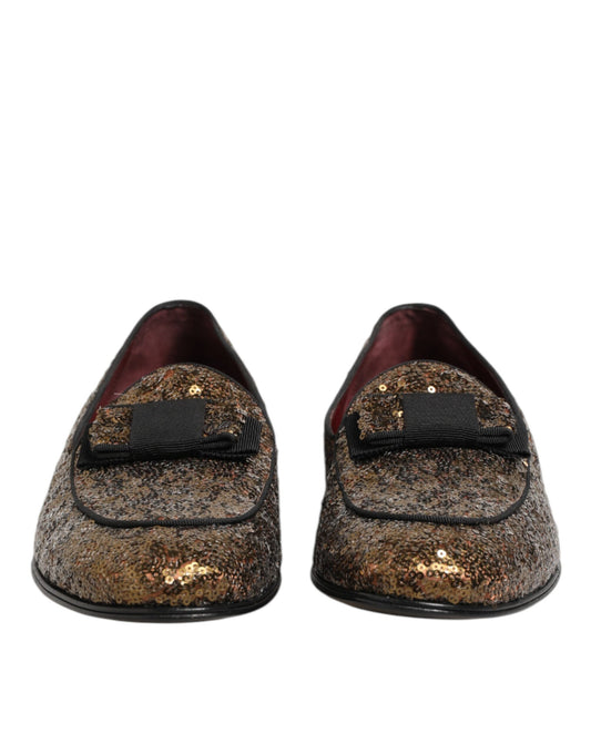 Pair of gold sequin loafers with black trim and elastic closure