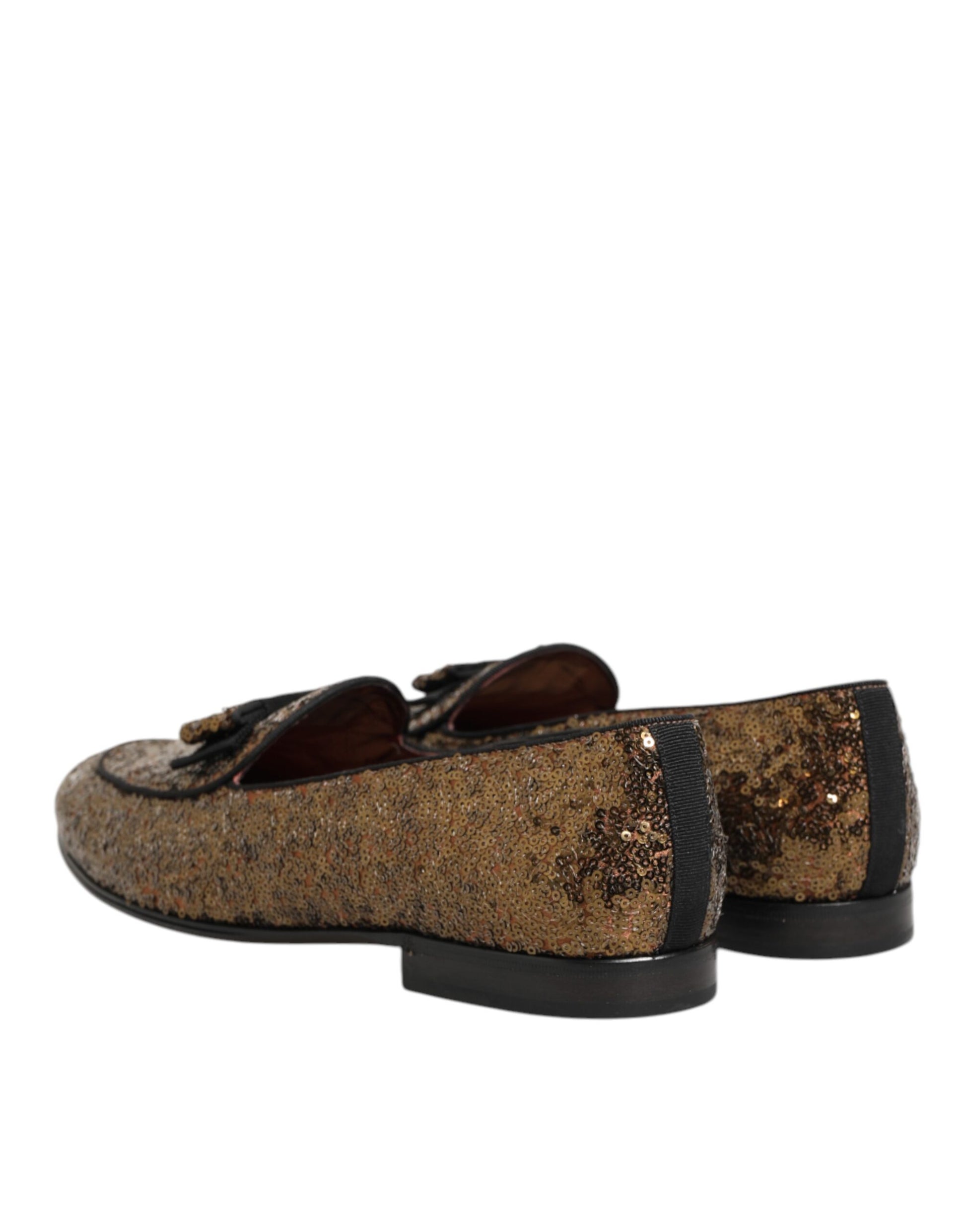 A pair of gold sequined loafers with a slip-on design