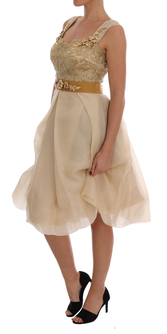 A woman wearing a gold silk dress with crystal embellishments