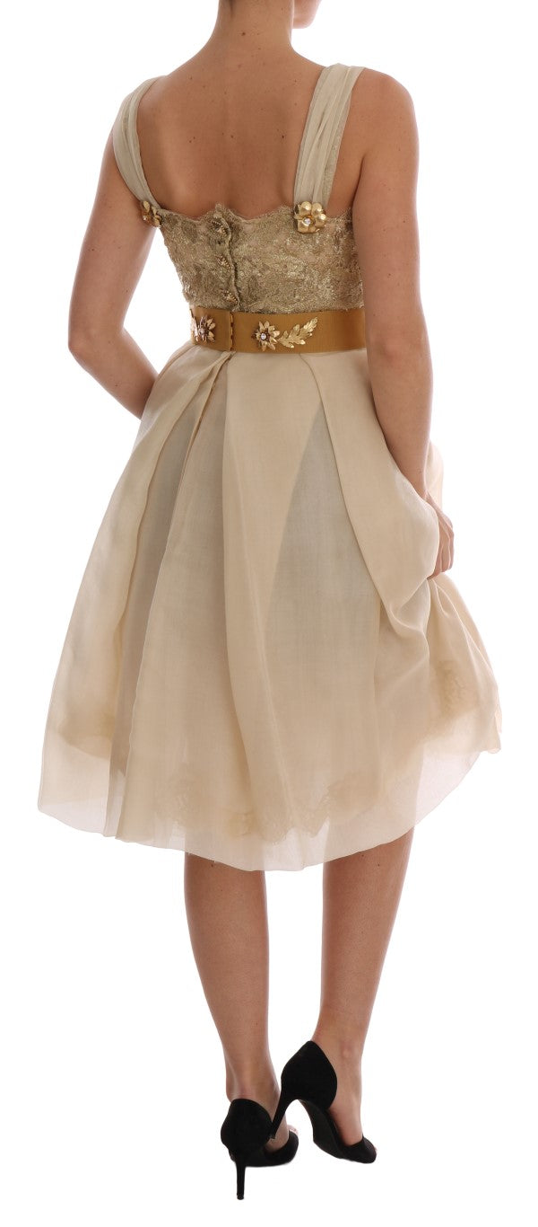 A woman wearing a gold silk dress with crystal embellishments
