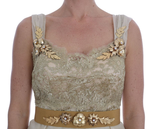 A gold silk dress with crystal embellishments and a leaf design belt