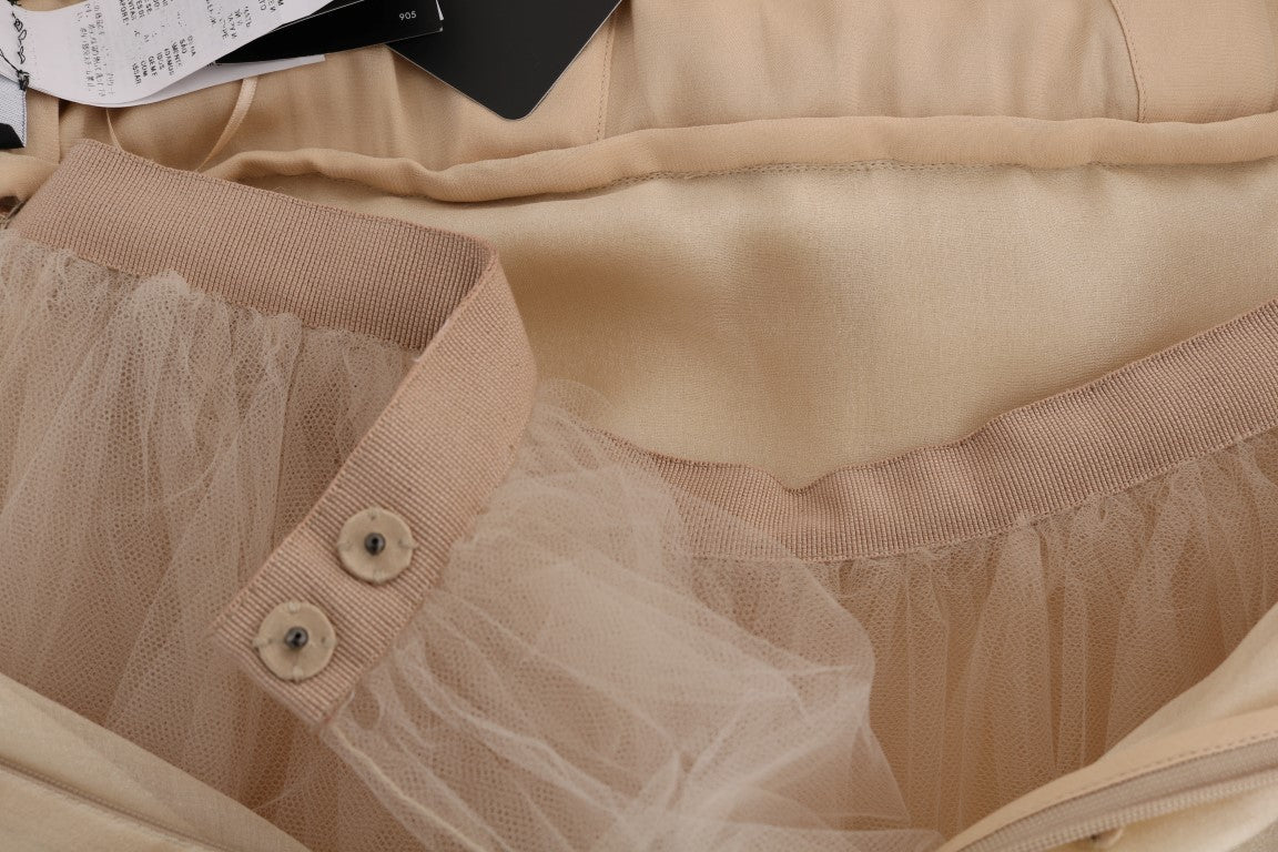 A gold silk dress with crystal embellishments and a sheer overlay