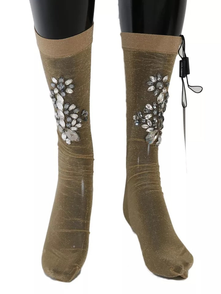 Pair of gold glittery boots with embellishments on legs