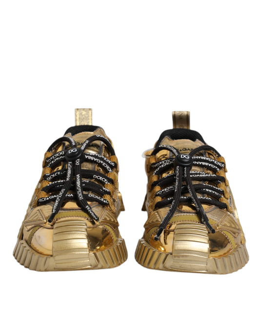 Pair of gold sneakers with black laces