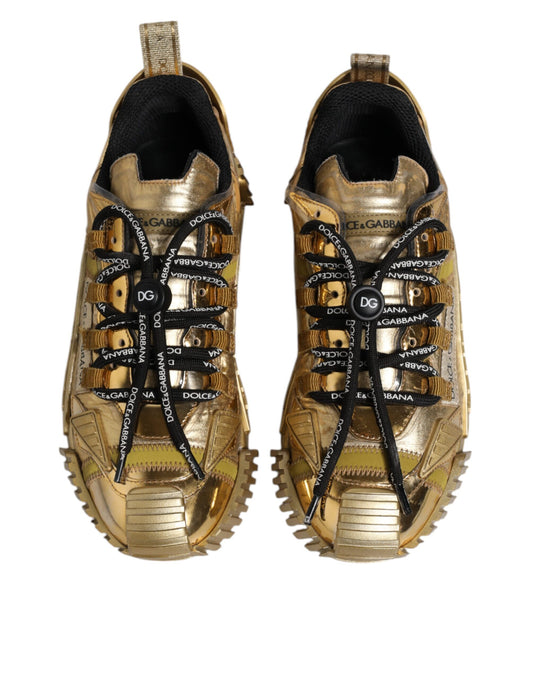 Pair of gold sneakers with black laces