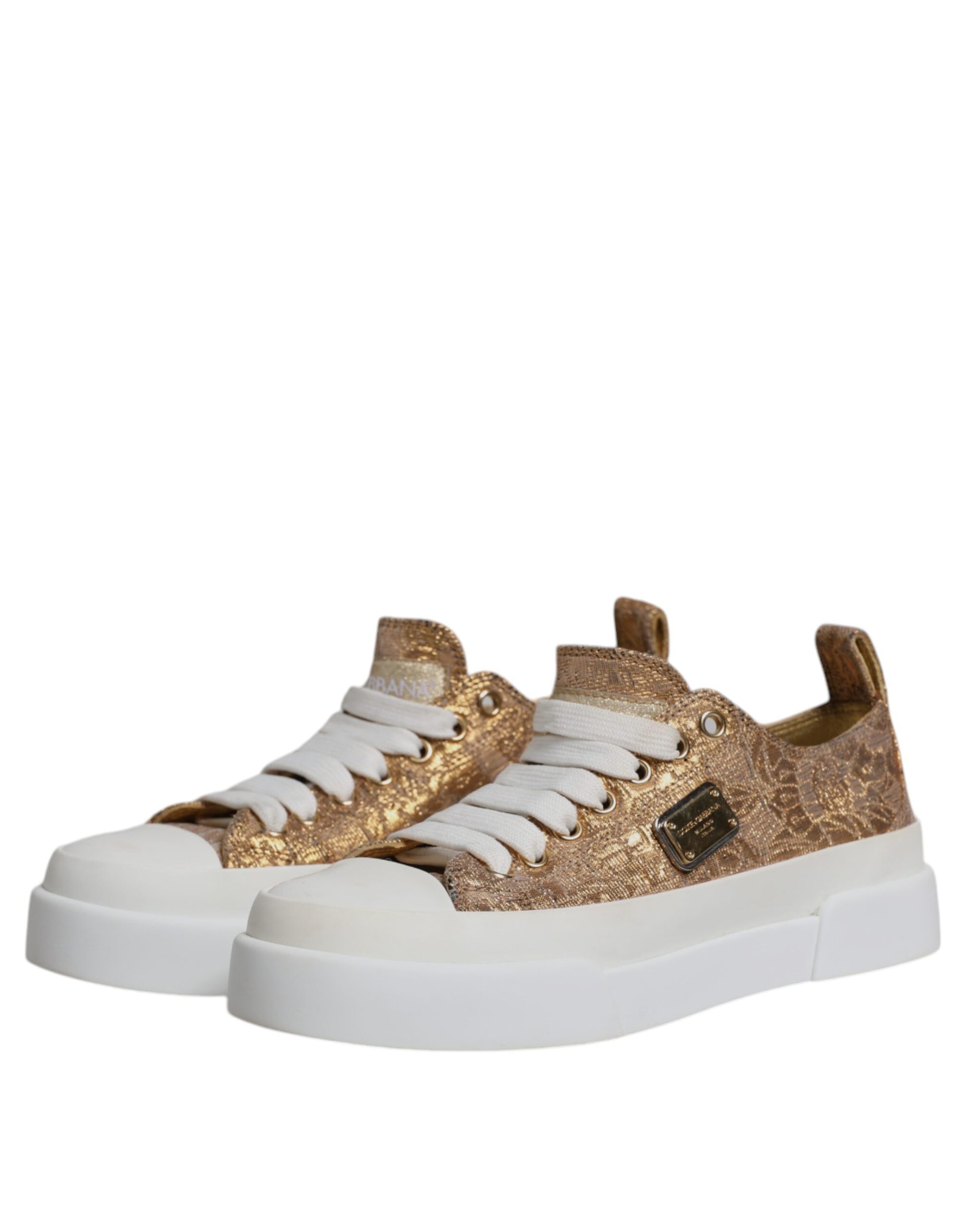 A pair of white sneakers with gold accents, featuring a logo on the side and a low top design