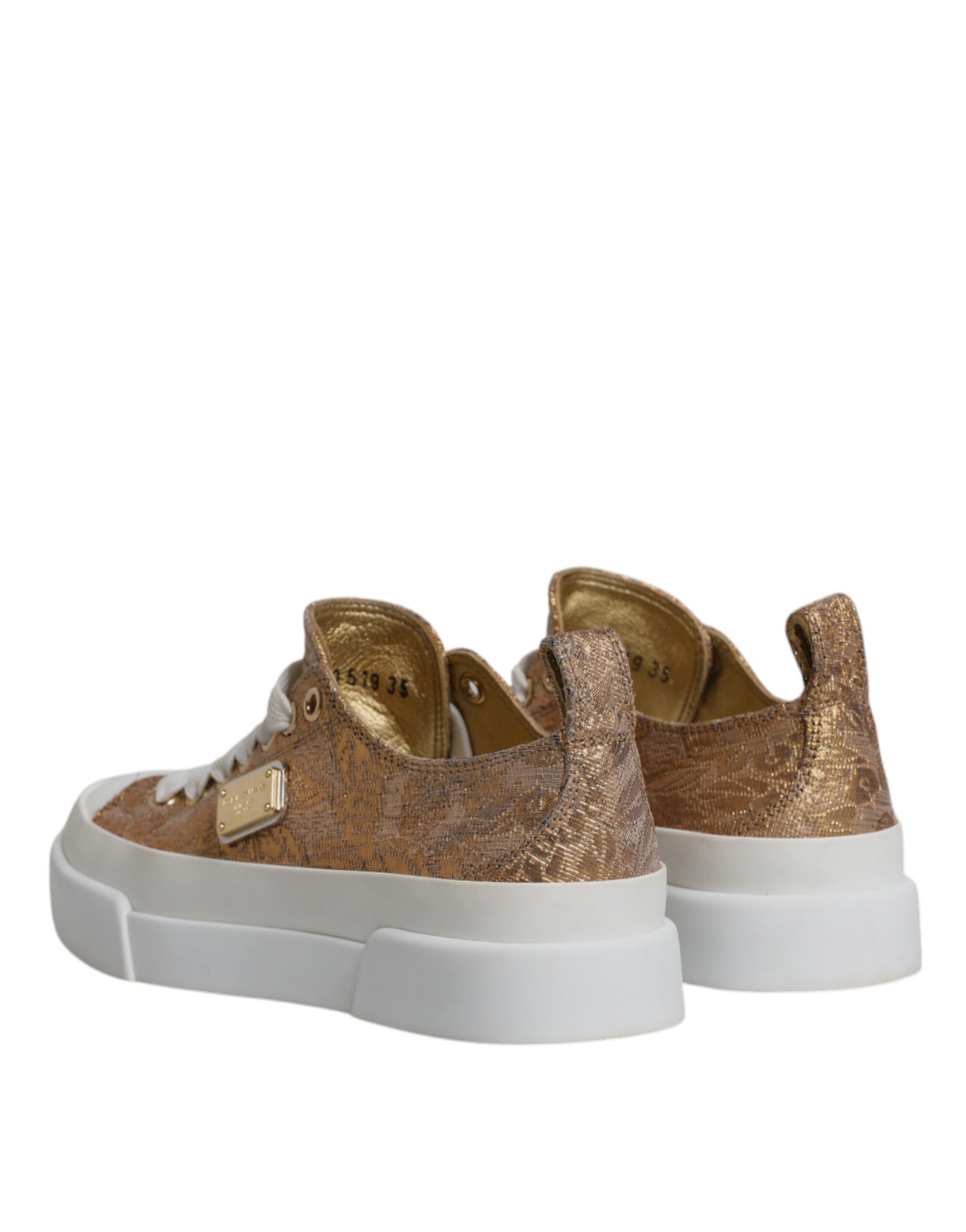 Pair of gold and white sneakers with logo detailing