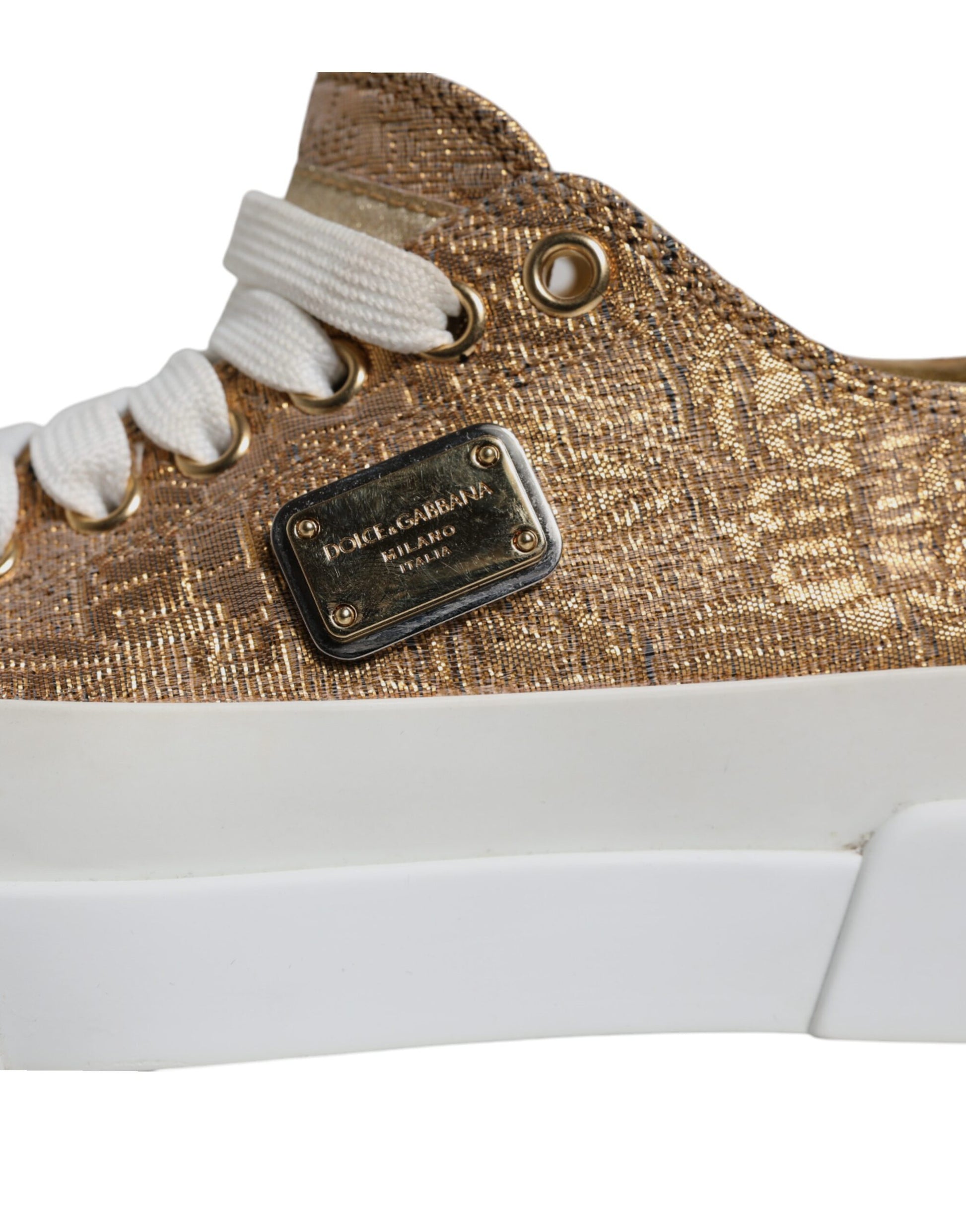 Gold and white sneakers with a logo on the side