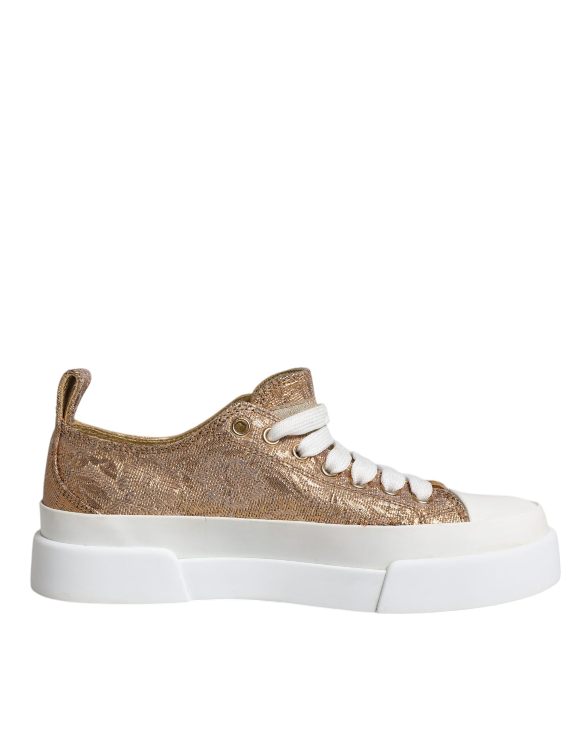 A pair of gold and white sneakers with a glittery texture, featuring the logo of Dolce & Gabbana