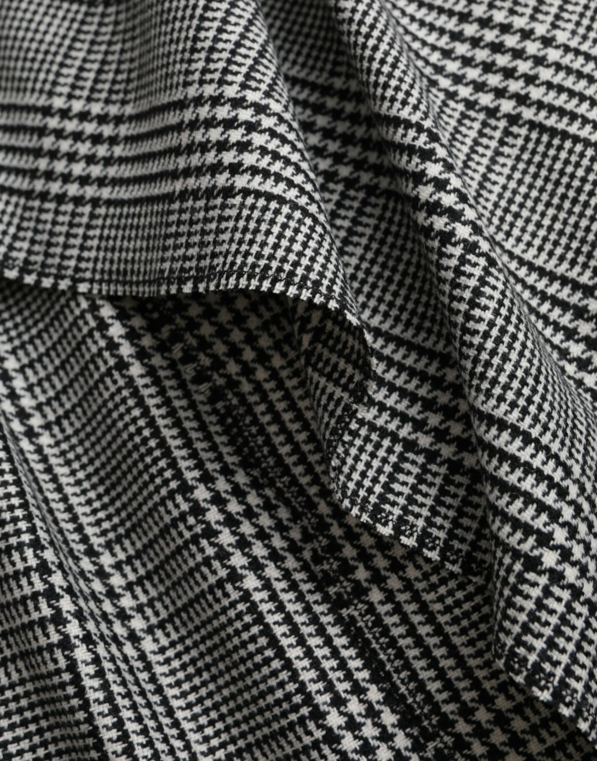 A layered one shoulder maxi dress in gray and beige with a patterned design