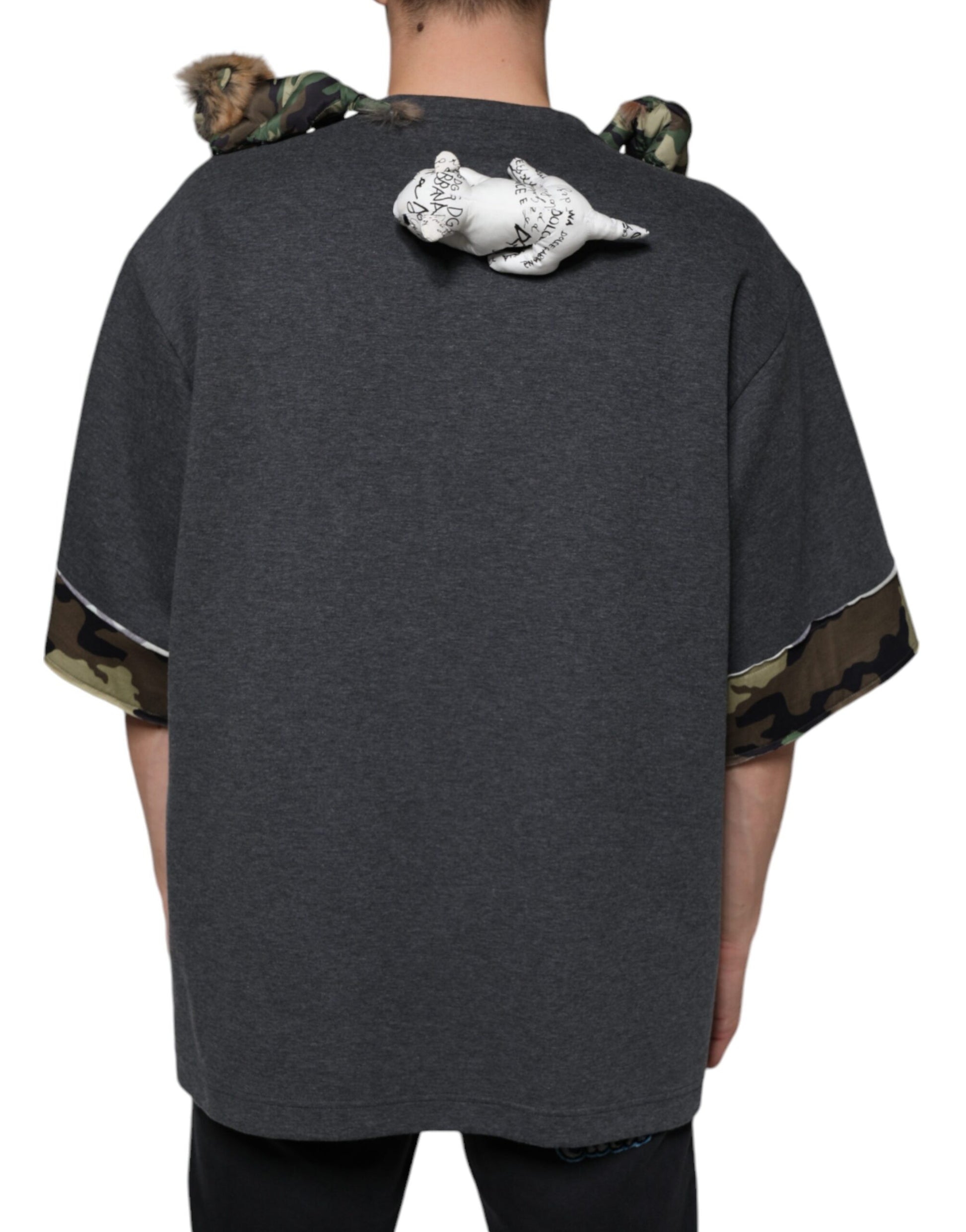 Man wearing a grey hoodie with camouflage sleeves and back
