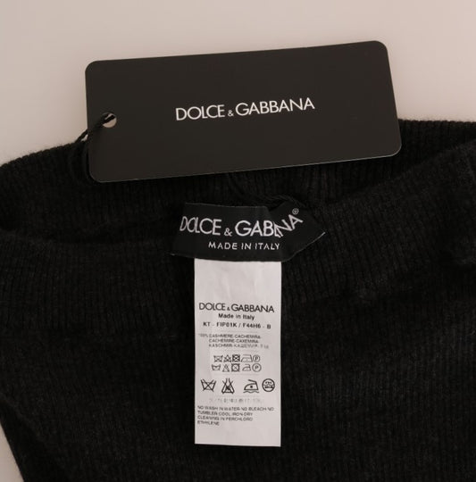 Black sweater on hanger with brand tag